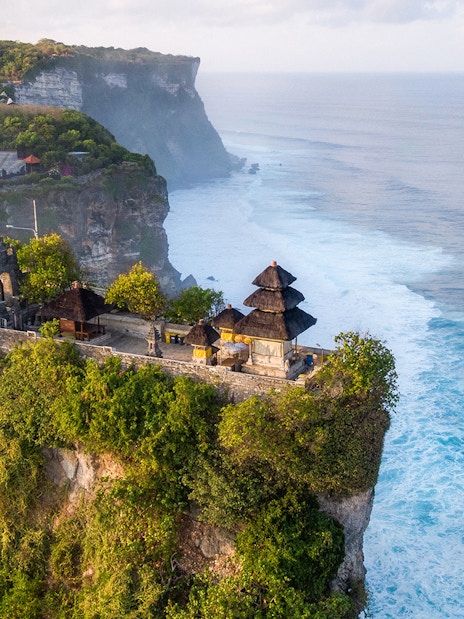 Uluwatu Temple perched on a cliff overlooking the ocean in Bali, Indonesia.