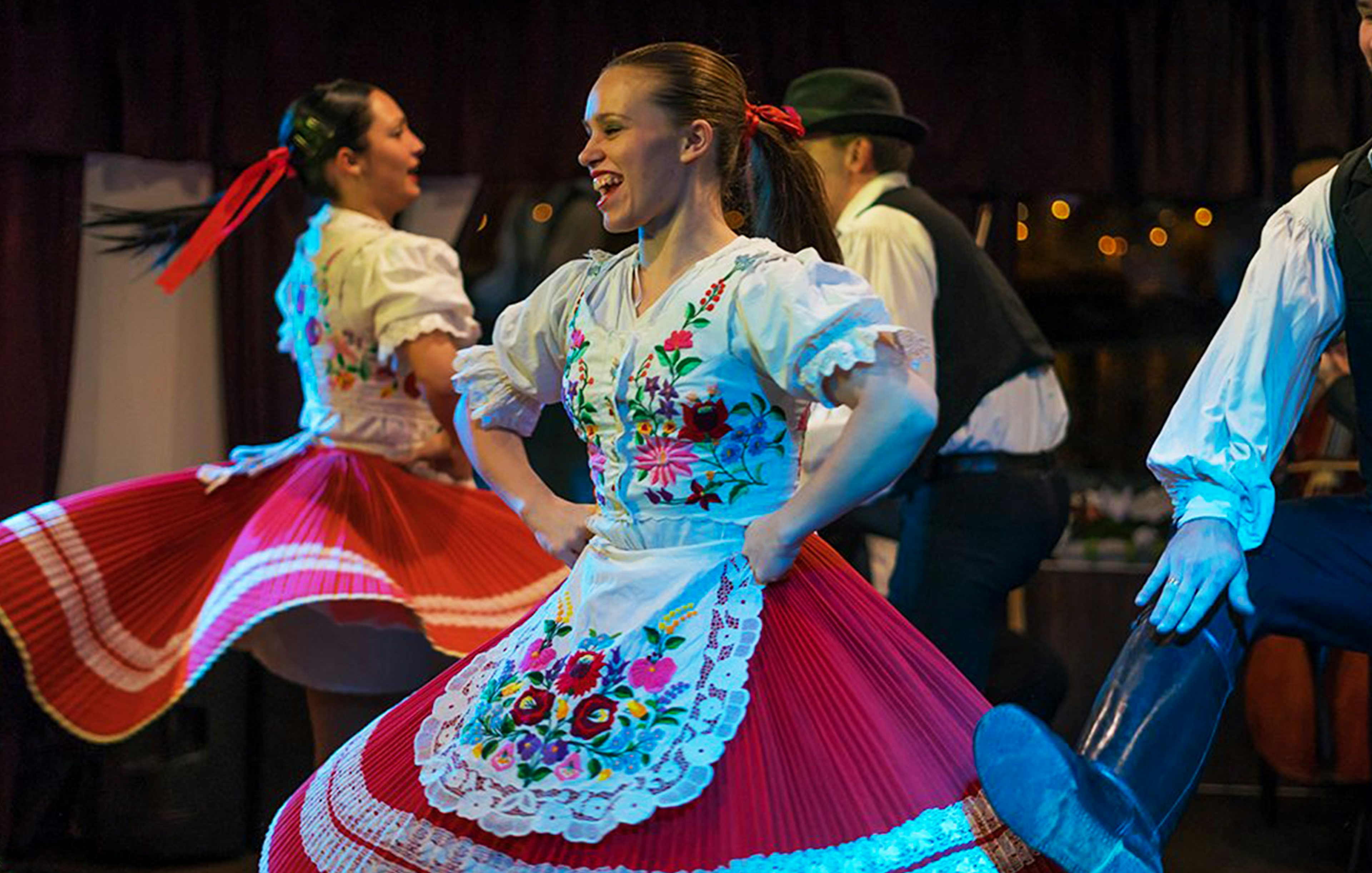 Folk dancers performing in traditional attire during a Budapest dinner cruise.