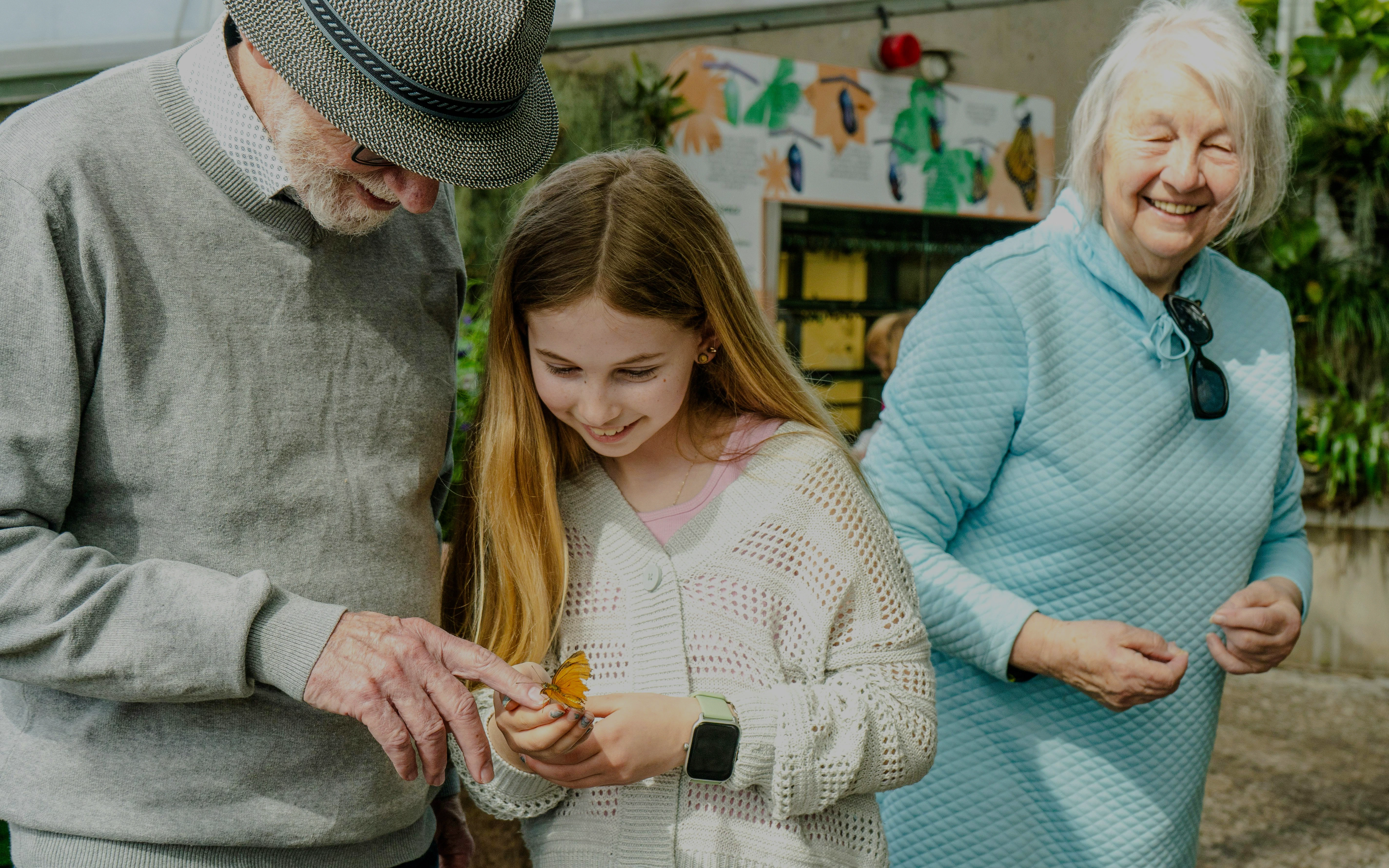 Visitors interacting with a butterfly at the Butterfly Conservatory, Niagara Falls, Canada.