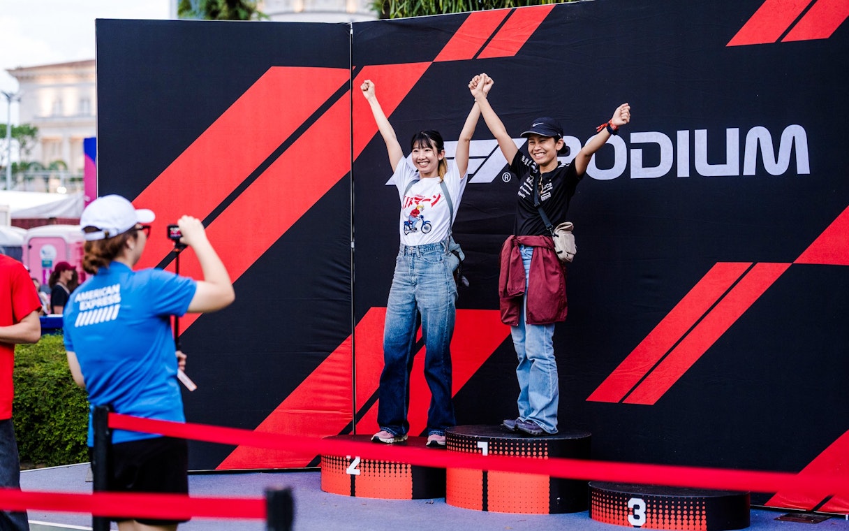 Participants posing on a podium at a circuit park photo opportunity.