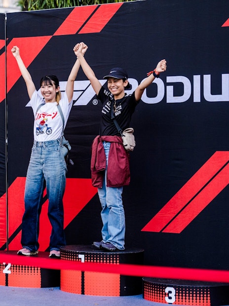 Participants posing on a podium at a circuit park photo opportunity.