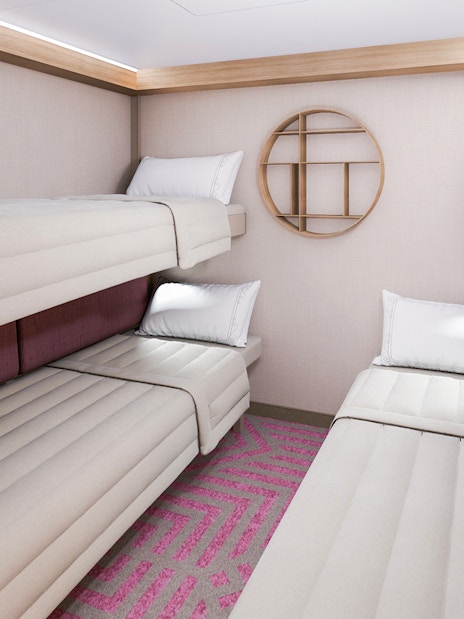 Inside stateroom with bunk beds and reef-themed decor on Disney Adventure Cruise.