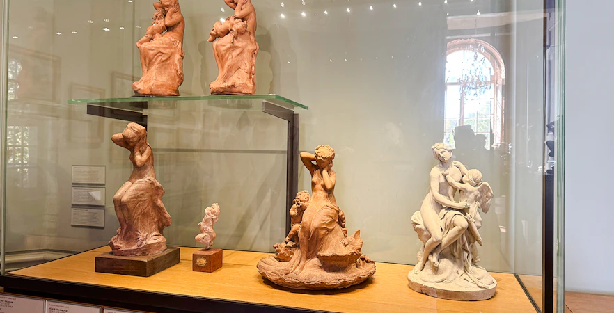 Sculptures in the Plaster Gallery at Rodin Museum, Paris, showcasing intricate figures.