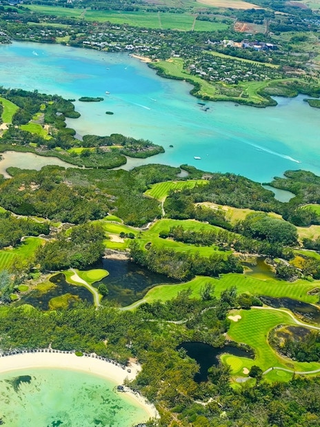 Aerial view of lush coastline and turquoise waters on the Short Amber Route Seaplane Tour, Mauritius.
