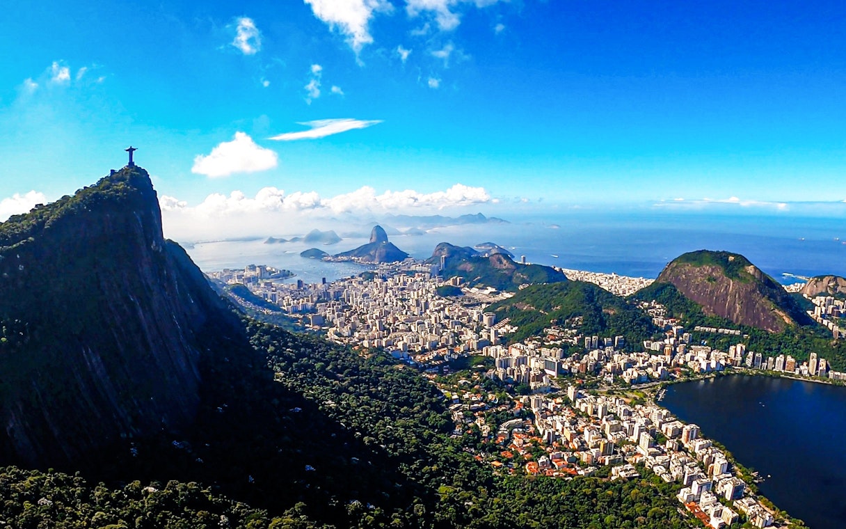 Christ the Redeemer overlooking Rio de Janeiro with Sugarloaf Mountain in the background.
