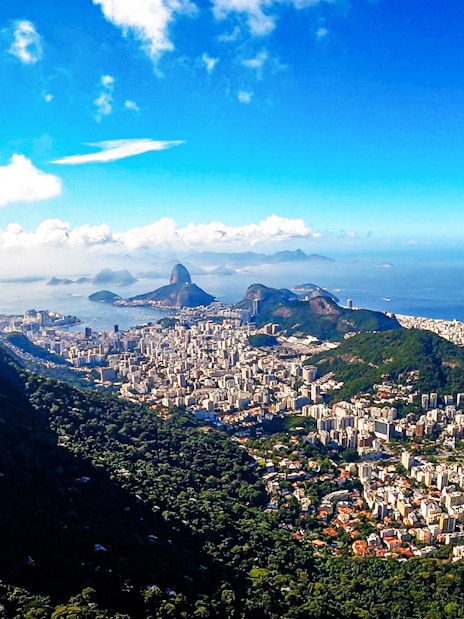 Christ the Redeemer overlooking Rio de Janeiro with Sugarloaf Mountain in the background.