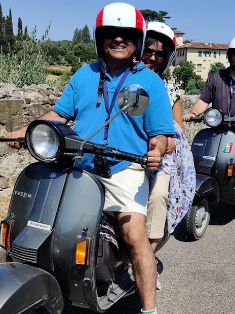 Group riding Vespas on a guided tour through Tuscany countryside from Florence.