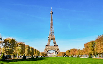 Eiffel Tower view from second floor with Paris cityscape in background.