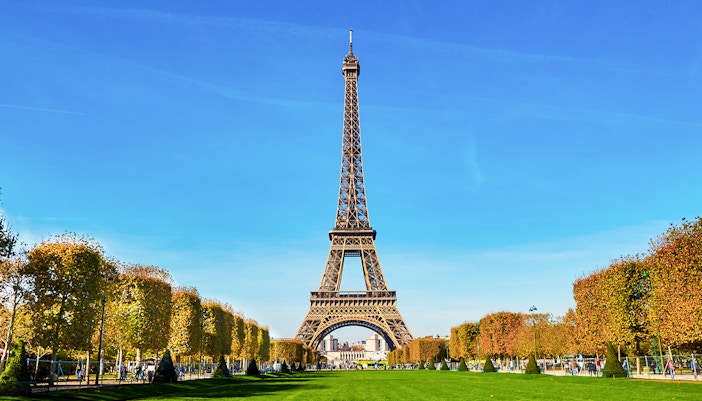Group of tourists with tickets enjoying the stunning view from the Eiffel Tower's summit in Paris, with a hosted entry
