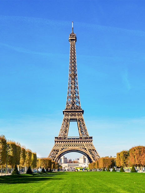 Eiffel Tower view from second floor with Paris cityscape in background.