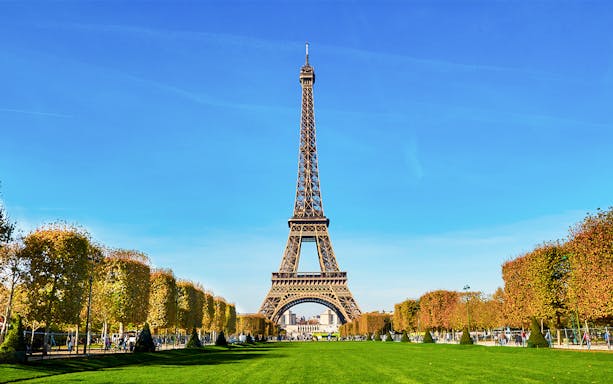 Eiffel Tower view from second floor with Paris cityscape in background.