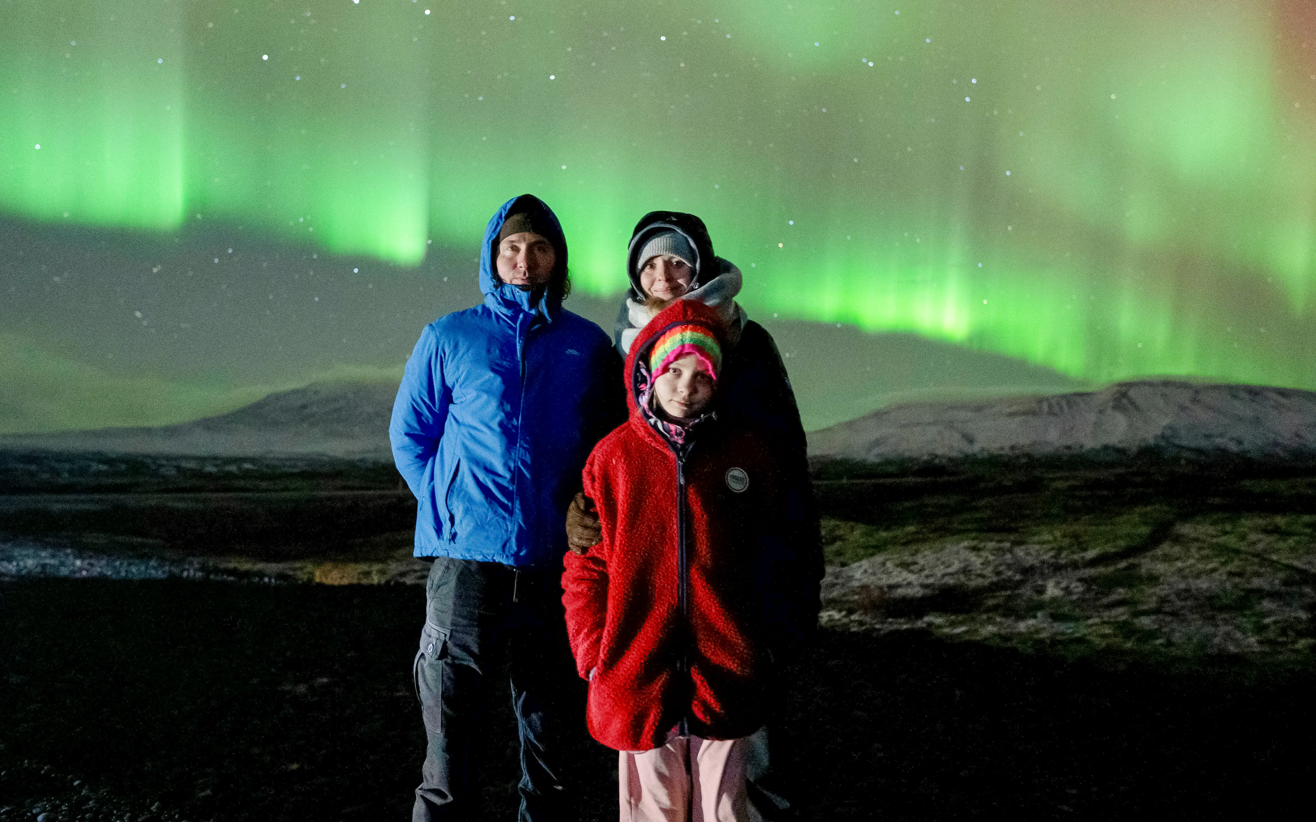 Tourists viewing Northern Lights in Reykjavik, Iceland.