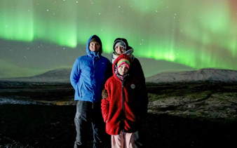 Tourists viewing Northern Lights in Reykjavik, Iceland.