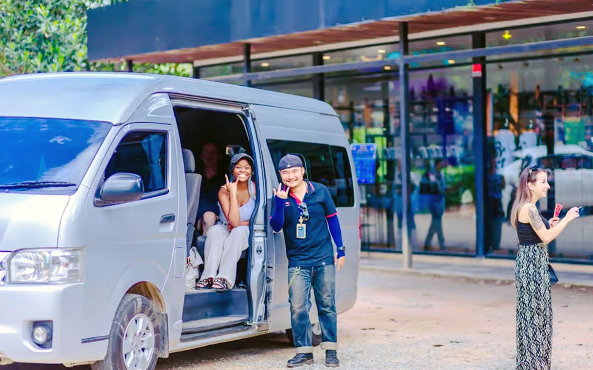 Van with passengers and driver for round-trip transfers from Chiang Mai.