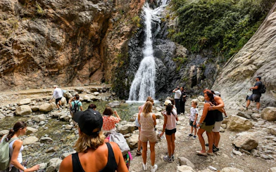 Tourists exploring waterfall in Ourika Valley, Atlas Mountains, Marrakech.