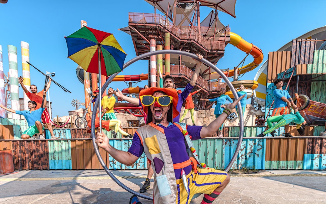Performers at entertainment event in Meryal Waterpark with colorful costumes and props.