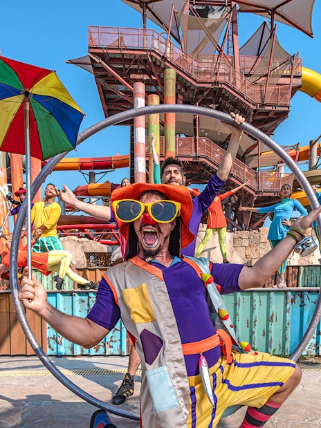 Performers at entertainment event in Meryal Waterpark with colorful costumes and props.