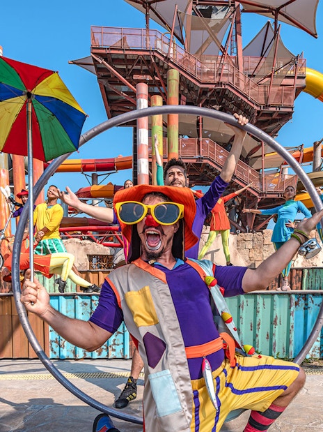 Performers at entertainment event in Meryal Waterpark with colorful costumes and props.