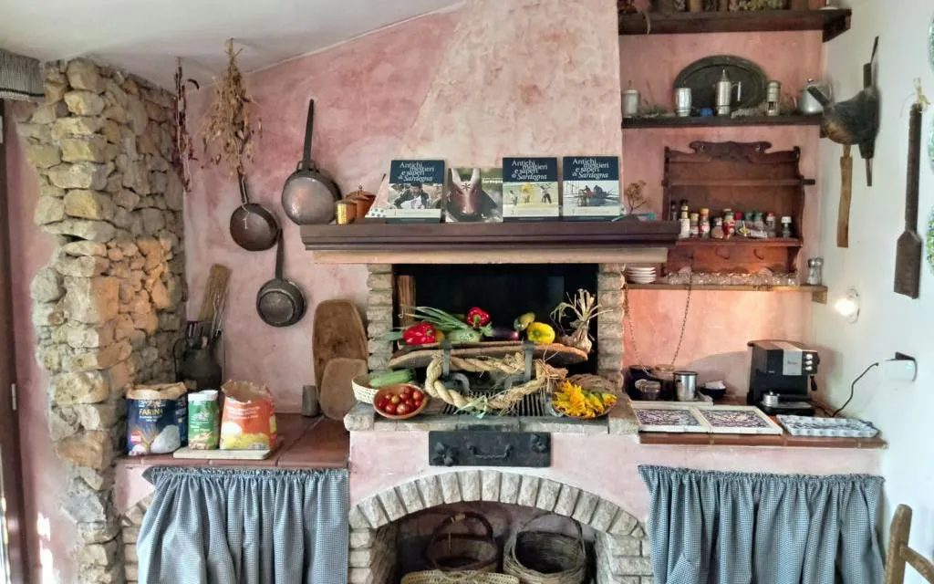 Rustic kitchen setup for Sardinian pasta-making class in Alghero, featuring traditional tools and ingredients.
