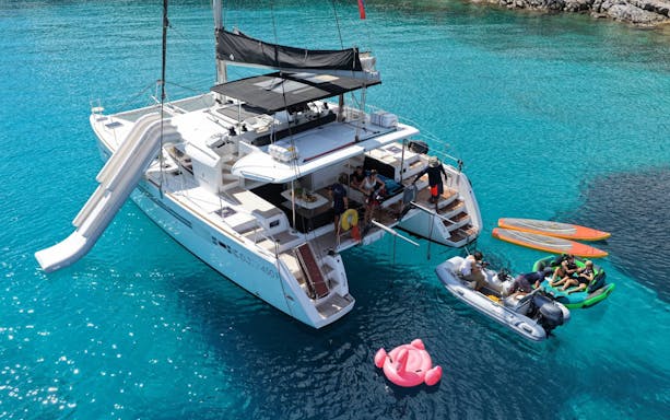 Catamaran with slide and paddleboards near Spinalonga, Crete.