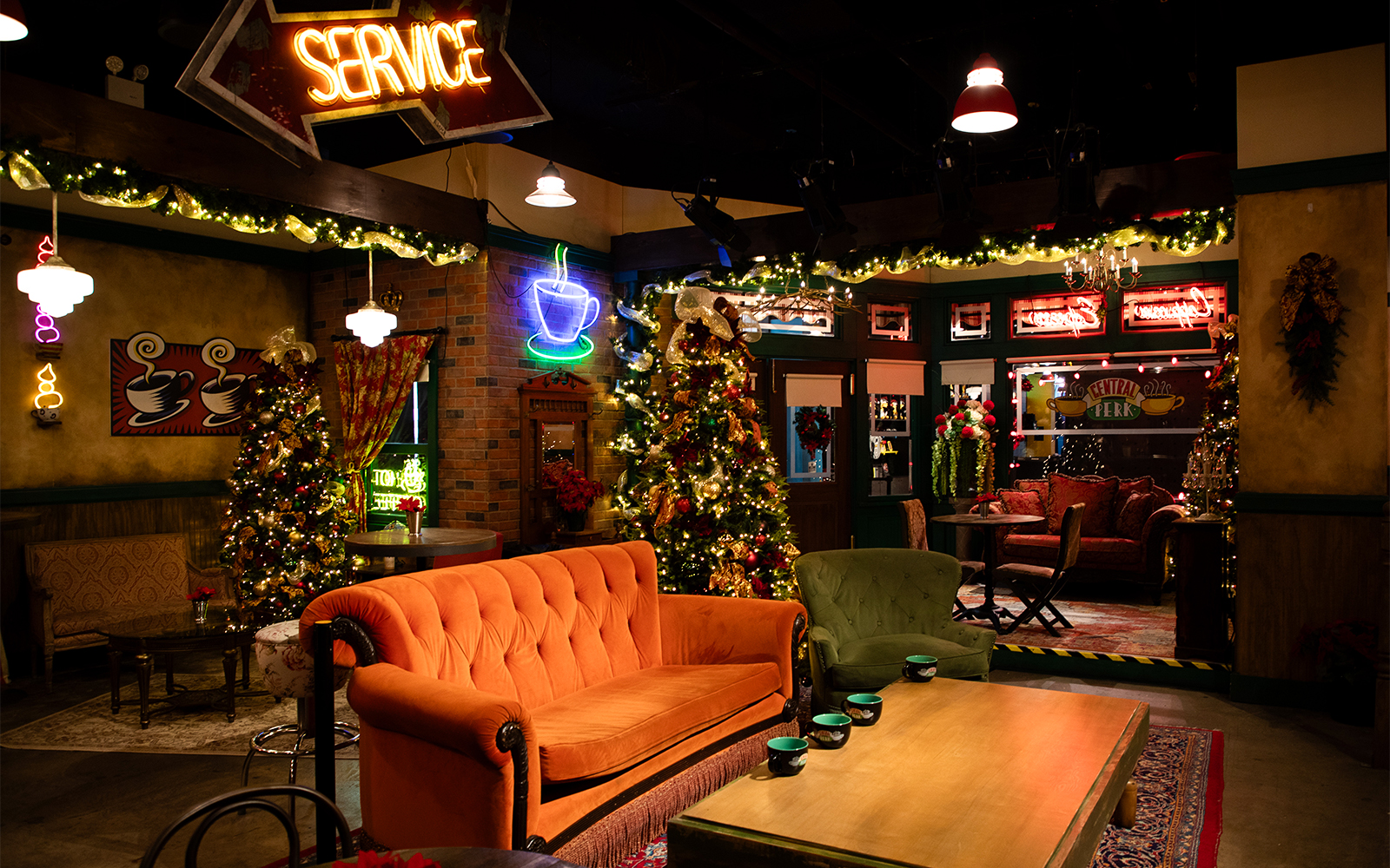 Central Perk set with orange couch and holiday decorations at The FRIENDS™ Experience.