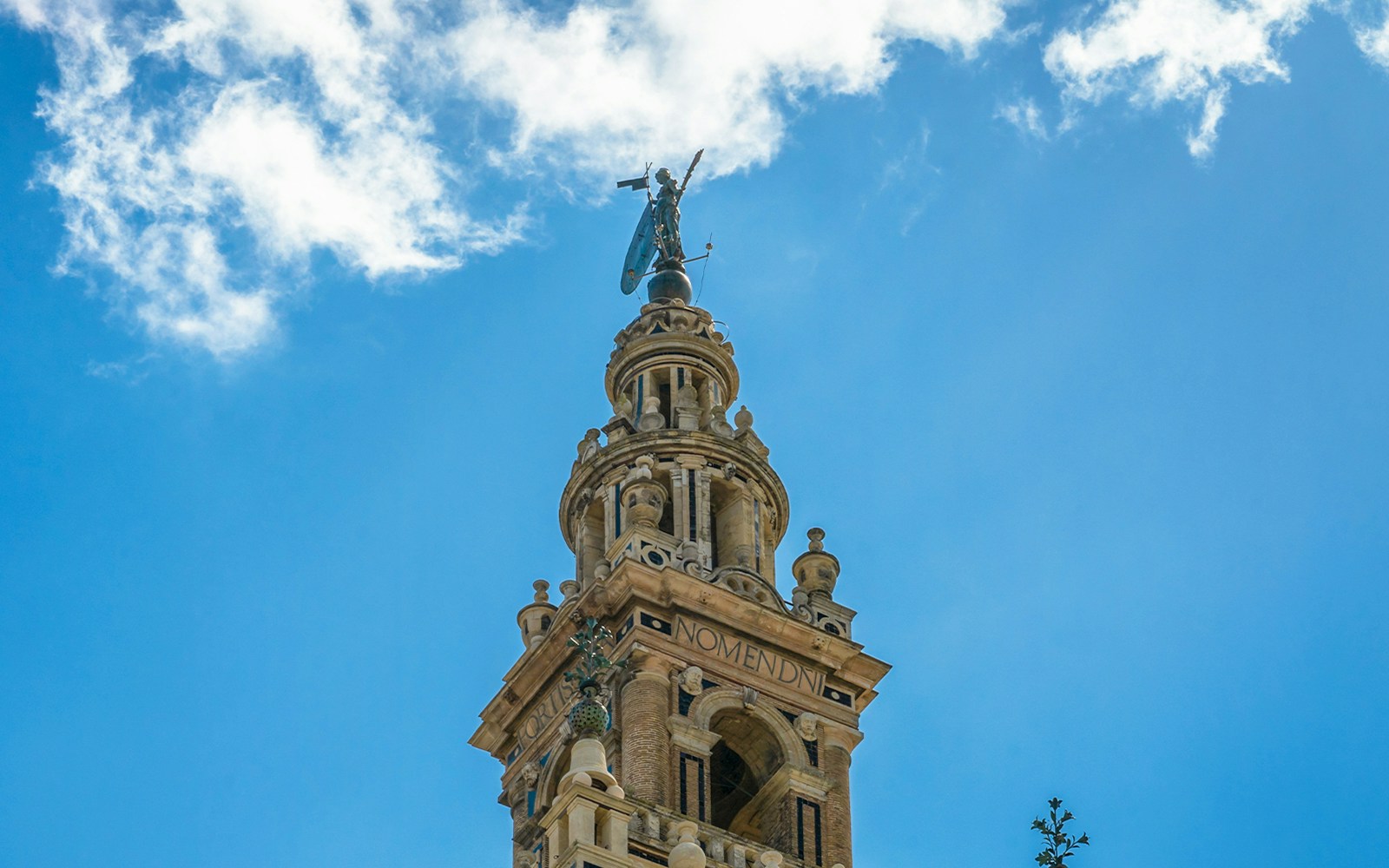 La Giralda bell tower with El Giraldillo statue, Seville Cathedral, Spain.