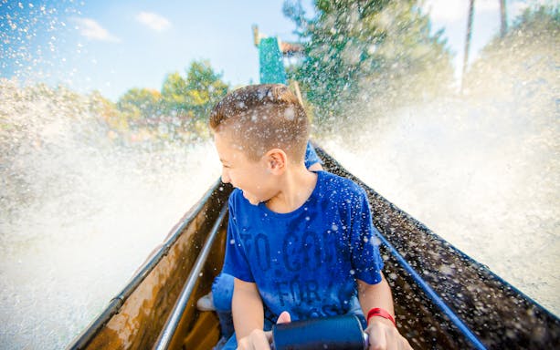 Child enjoying a water ride at Slagharen Wild West Theme Park, Netherlands.