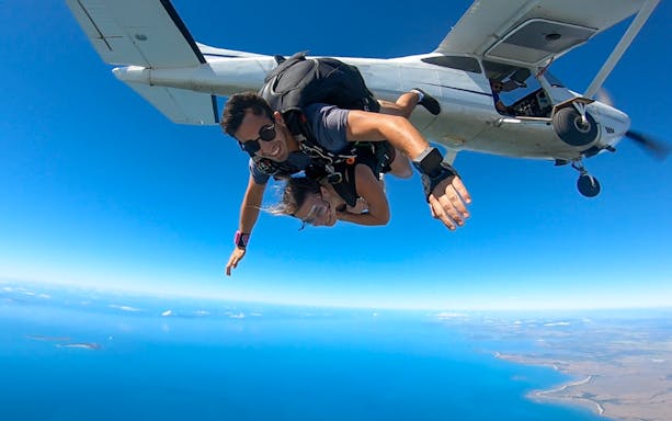 Tandem skydive over Airlie Beach with ocean view and beach landing.