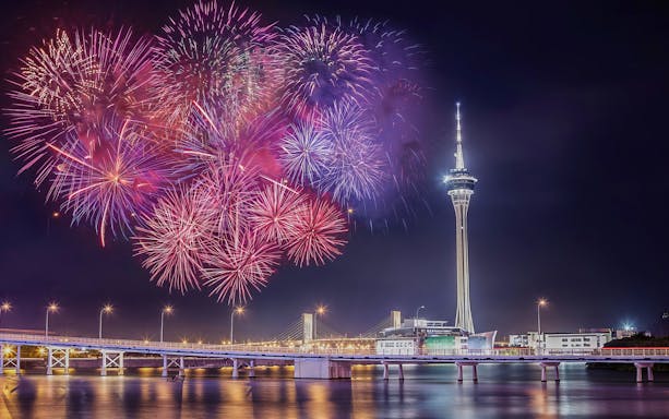 Fireworks over Macau Tower and bridge, view from Turbojet ferry transfer route.