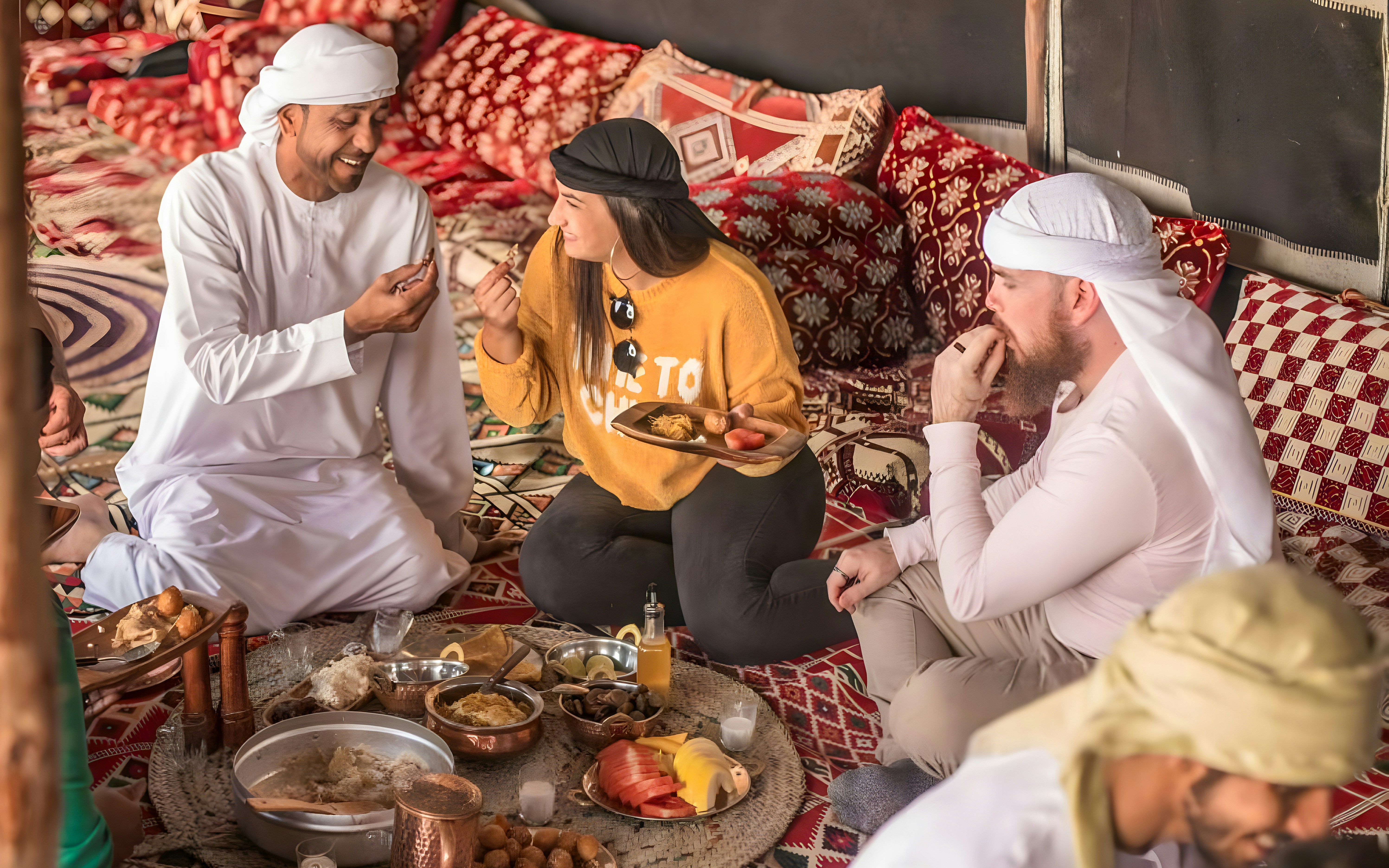 Family enjoying lunch at Bedouin Culture Safari, Dubai desert setting