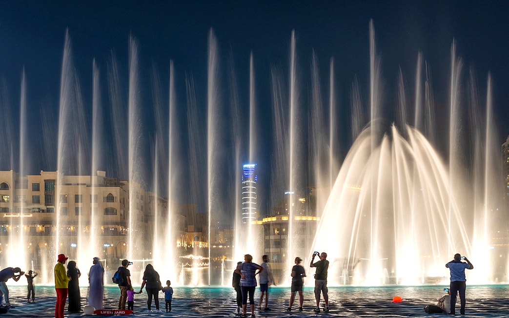 People watching the Dubai fountain show at night.