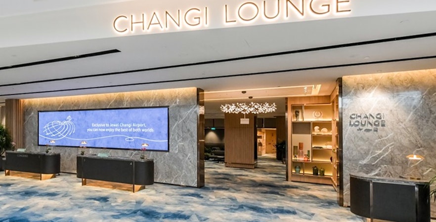 Entrance to Changi Lounge at Singapore Airport with modern decor and reception desks.