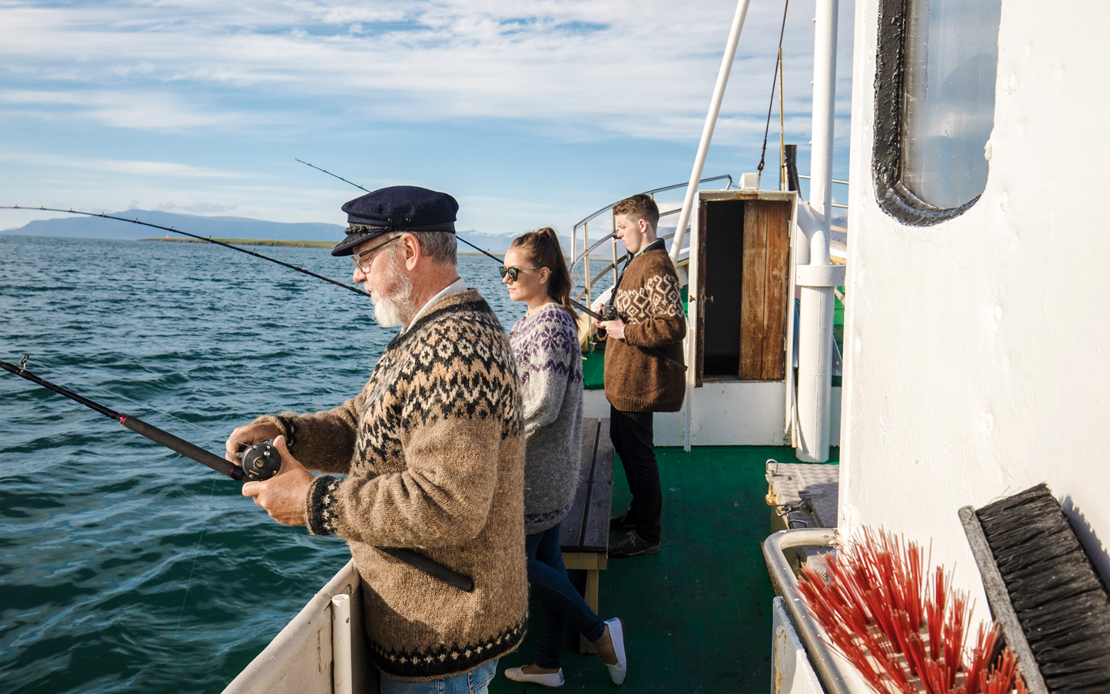 Guests fishing on a boat during Reykjavík Sea Angling Gourmet tour.