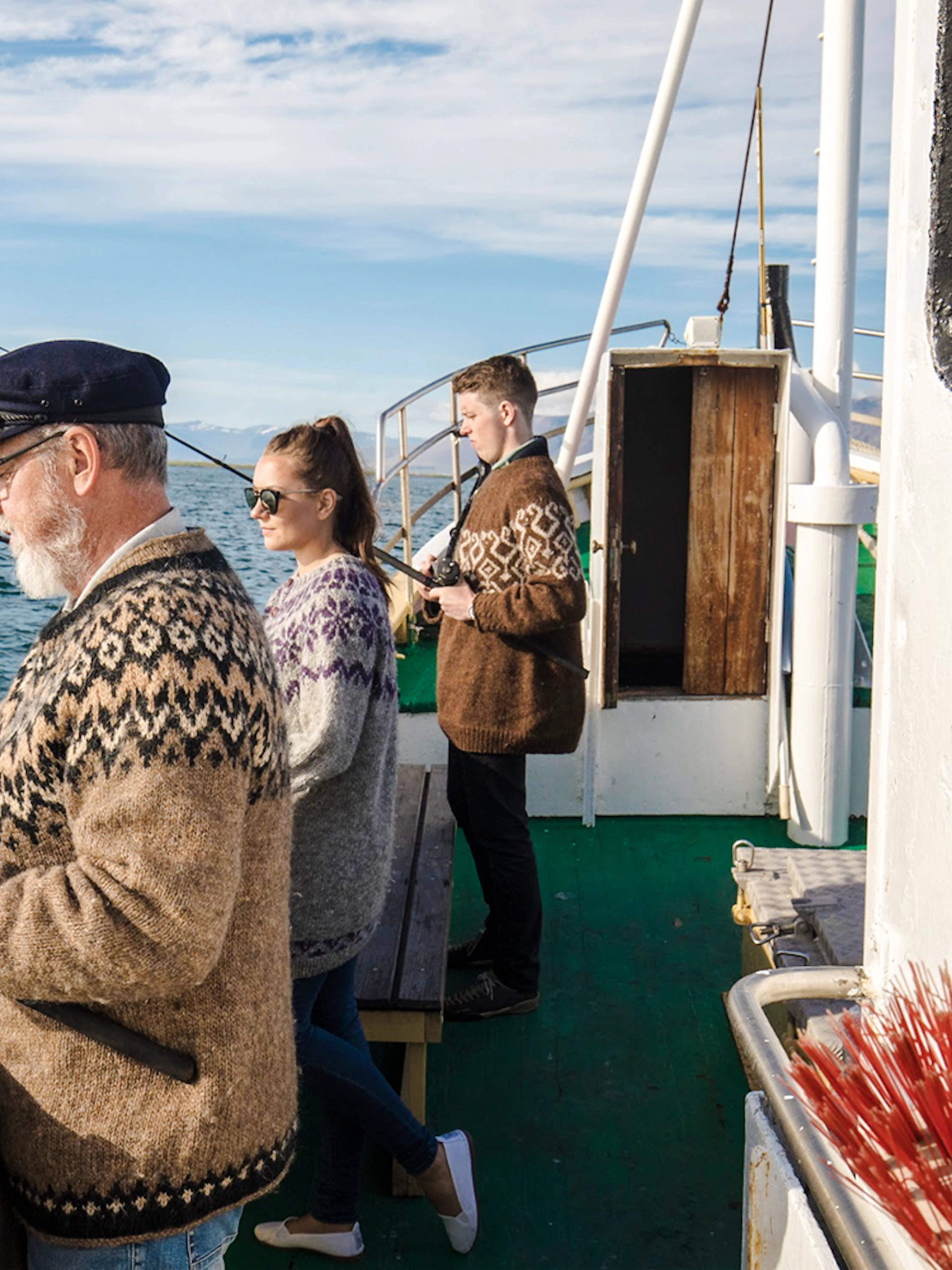 Guests fishing on a boat during Reykjavík Sea Angling Gourmet tour.