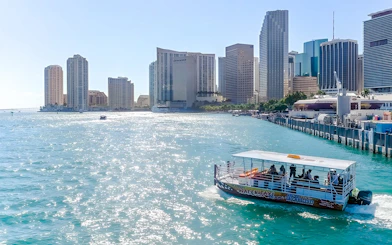 Cruise boat on Miami waters with downtown skyline in the background.