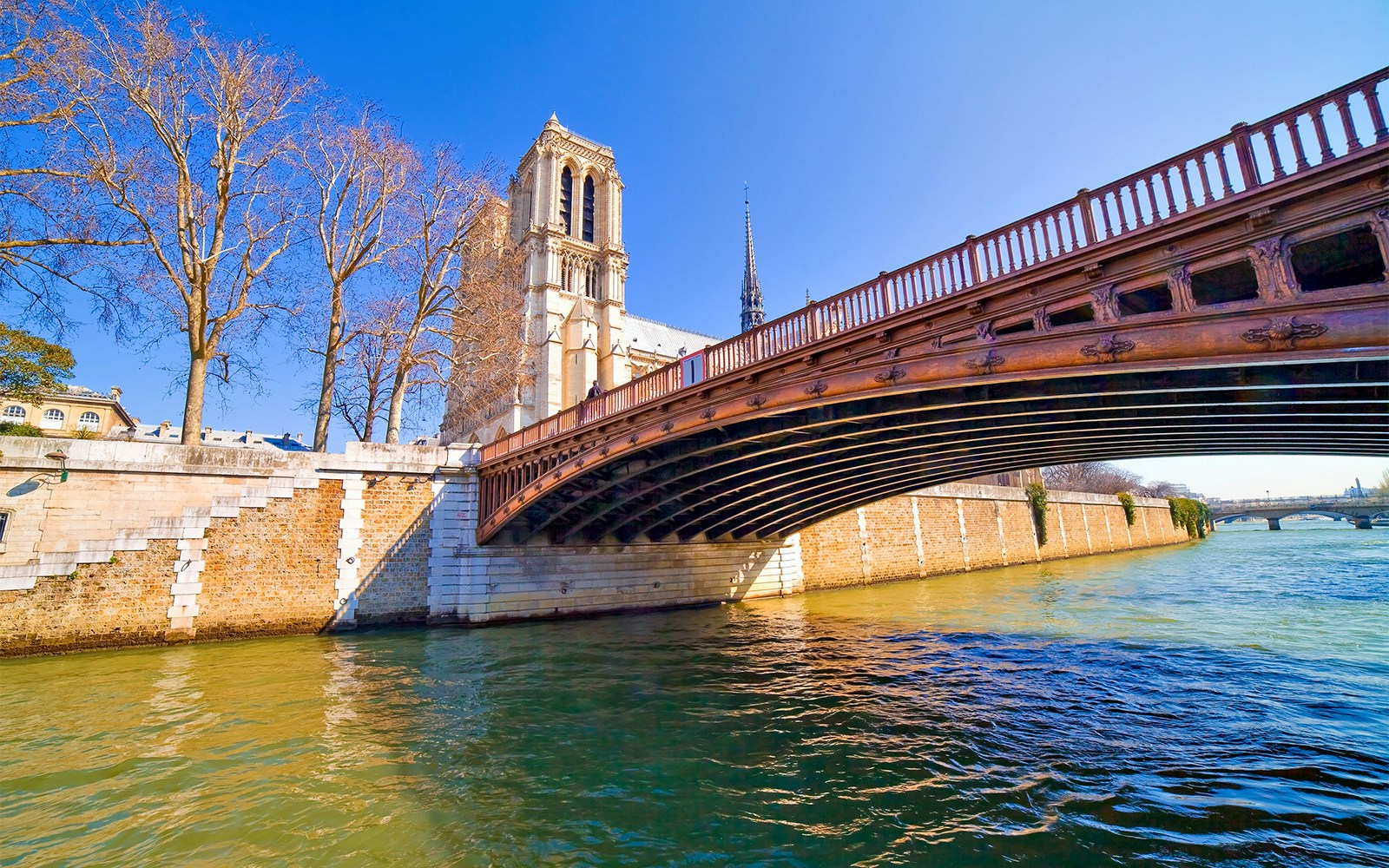 Pont au Double bridge over the Seine River on Île de la Cité, Paris, with historic architecture.