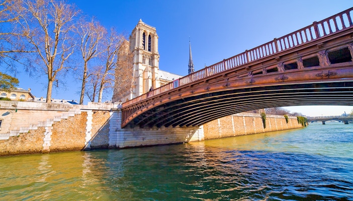 Pont au Double bridge over the Seine River on Île de la Cité, Paris, with historic architecture.