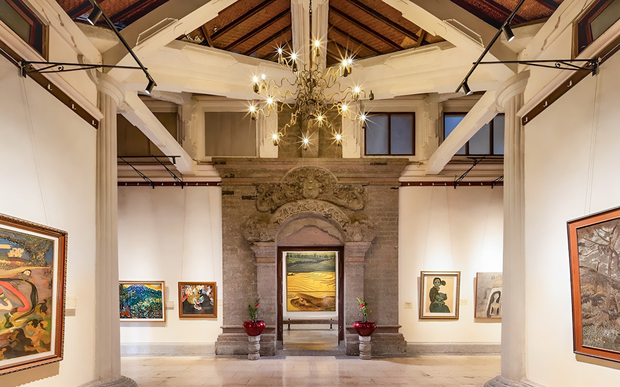 Interiors of Arma Museum Resort showcasing art gallery with paintings and ornate architecture.