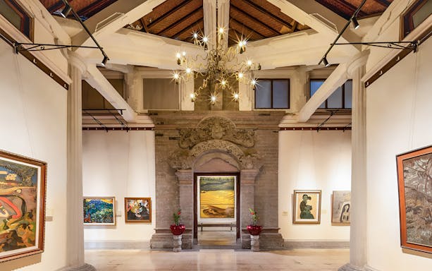 Interiors of Arma Museum Resort showcasing art gallery with paintings and ornate architecture.