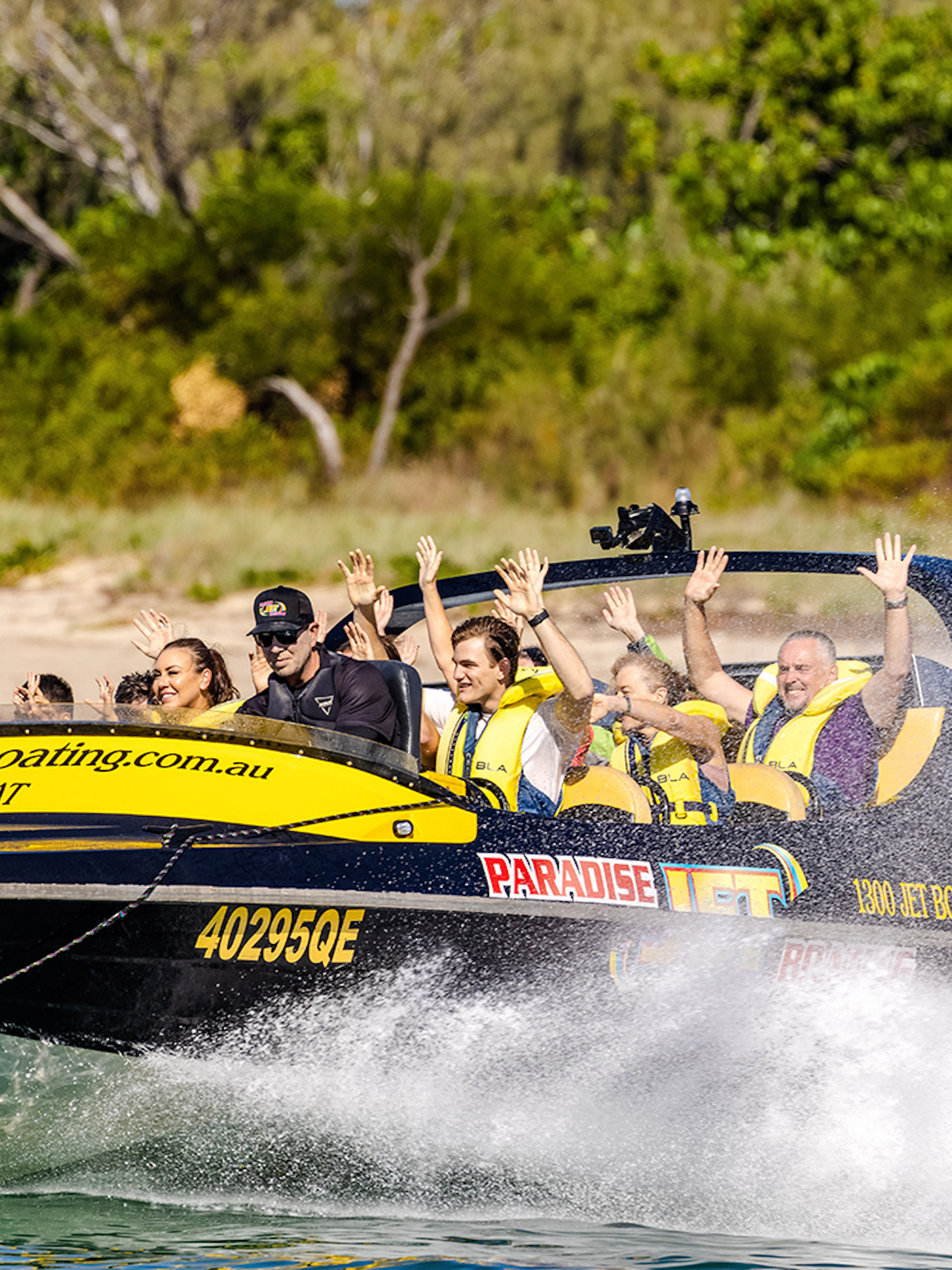 Jet boat with passengers enjoying a thrilling ride on Gold Coast waters.