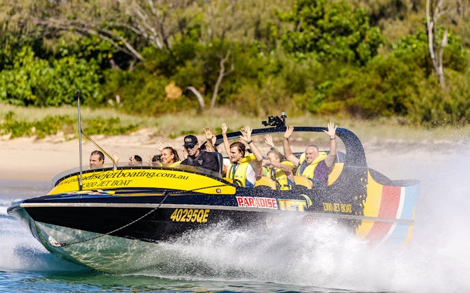 Jet boat with passengers enjoying a thrilling ride on Gold Coast waters.