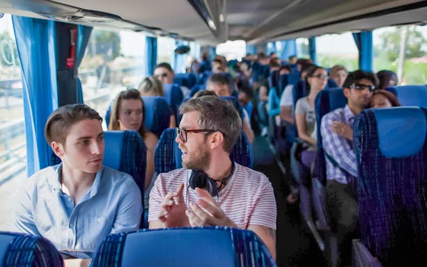 Passengers seated inside a Terravision bus heading to the airport.