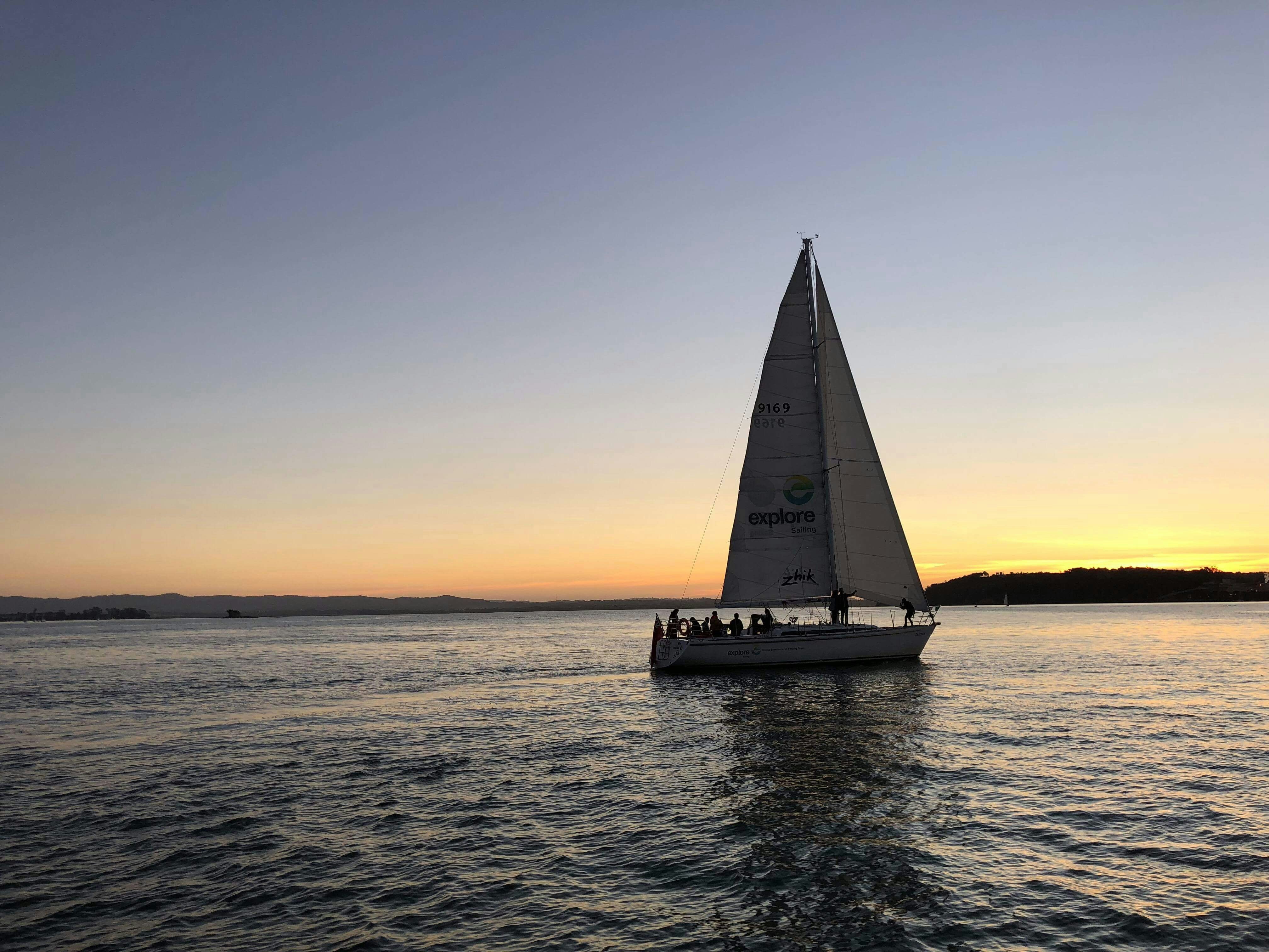 Sailboat on Auckland Harbour at sunset during 3-course dinner cruise.