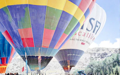 Hot air balloons preparing for flight at sunrise in Ihlara Canyon, Cappadocia.