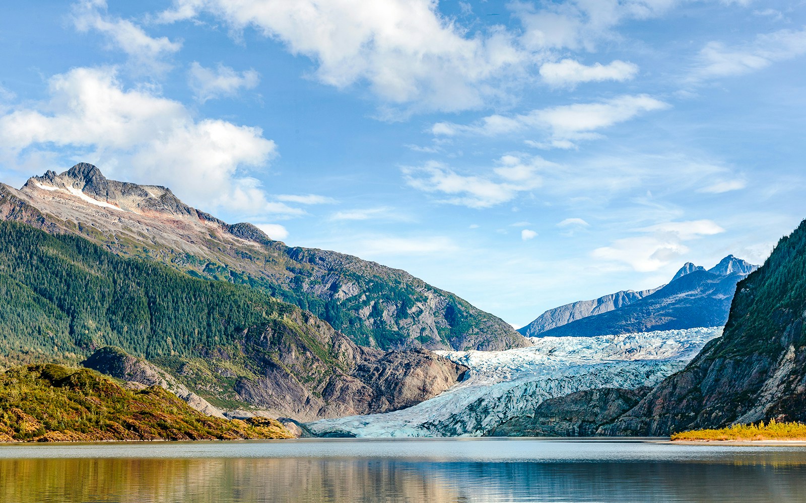 Mendenhall Glacier with surrounding mountains and lake in Juneau, Alaska.
