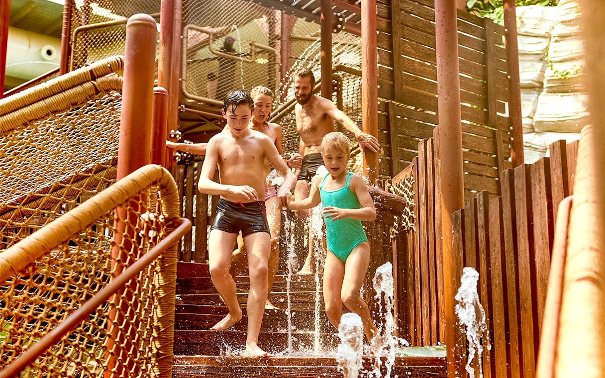 Tourists playing in the Aqua Fort section of Bellewaerde Aquapark.
