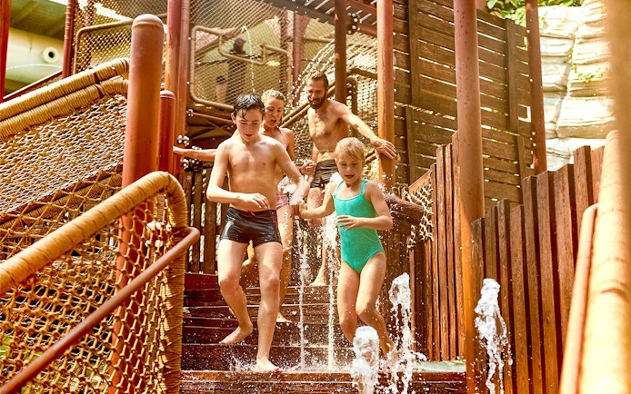 Tourists playing in the Aqua Fort section of Bellewaerde Aquapark.