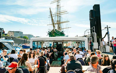Guests enjoying sightseeing on a boat during the 2-Hour XXL Port of Hamburg Cruise Tour.