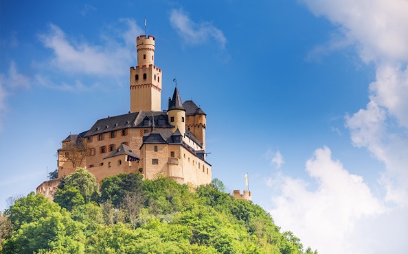 Marksburg Castle on a hilltop under a blue sky, Koblenz river cruise.