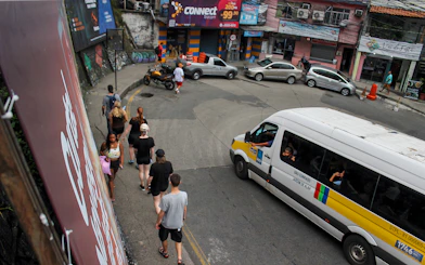 Tourists walking on a narrow street in a favela market, Rio de Janeiro.